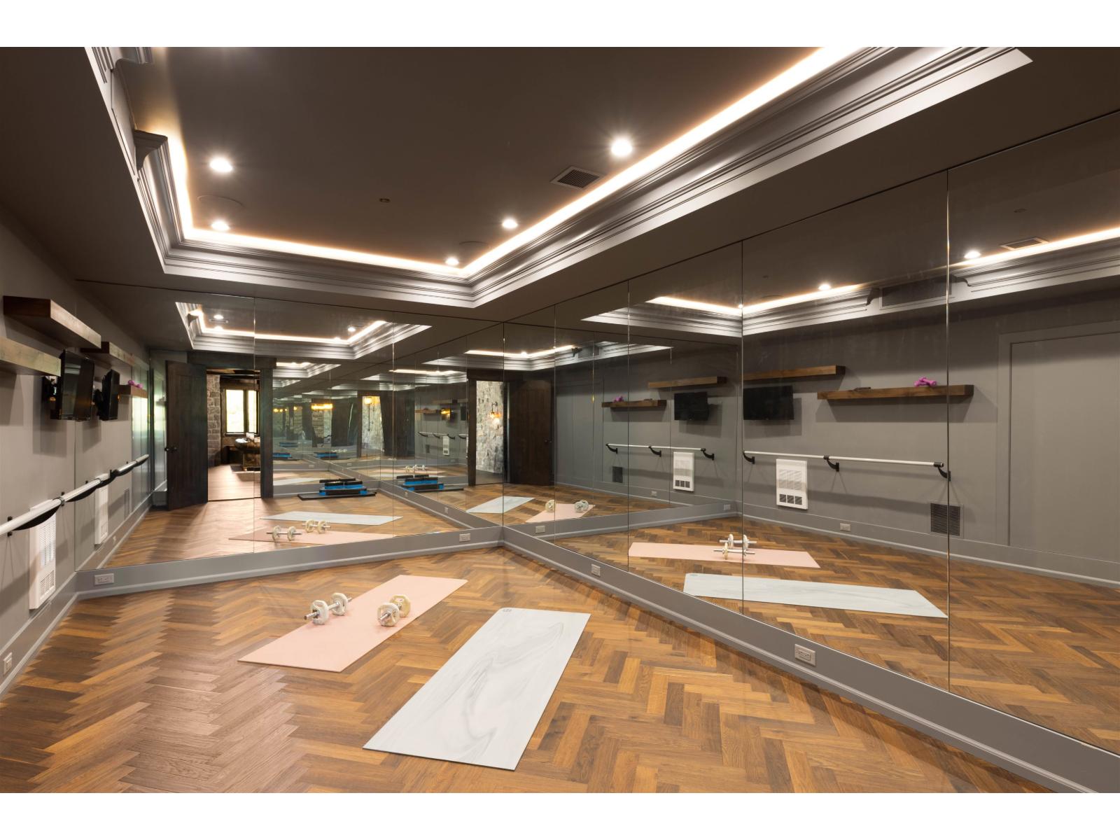 Mirrored movement studio with barre and hardwood floor