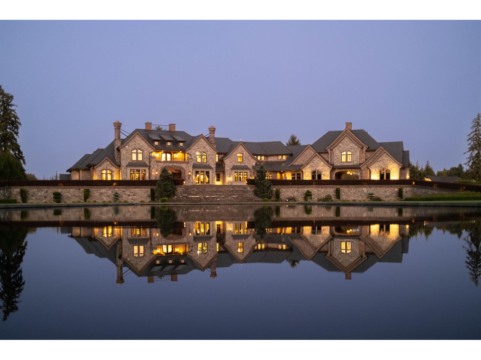 The estate mirrored in the reflecting pond at blue hour