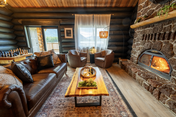 Lodge lounge with wood-burning fireplace, live-edge table and mountain views
