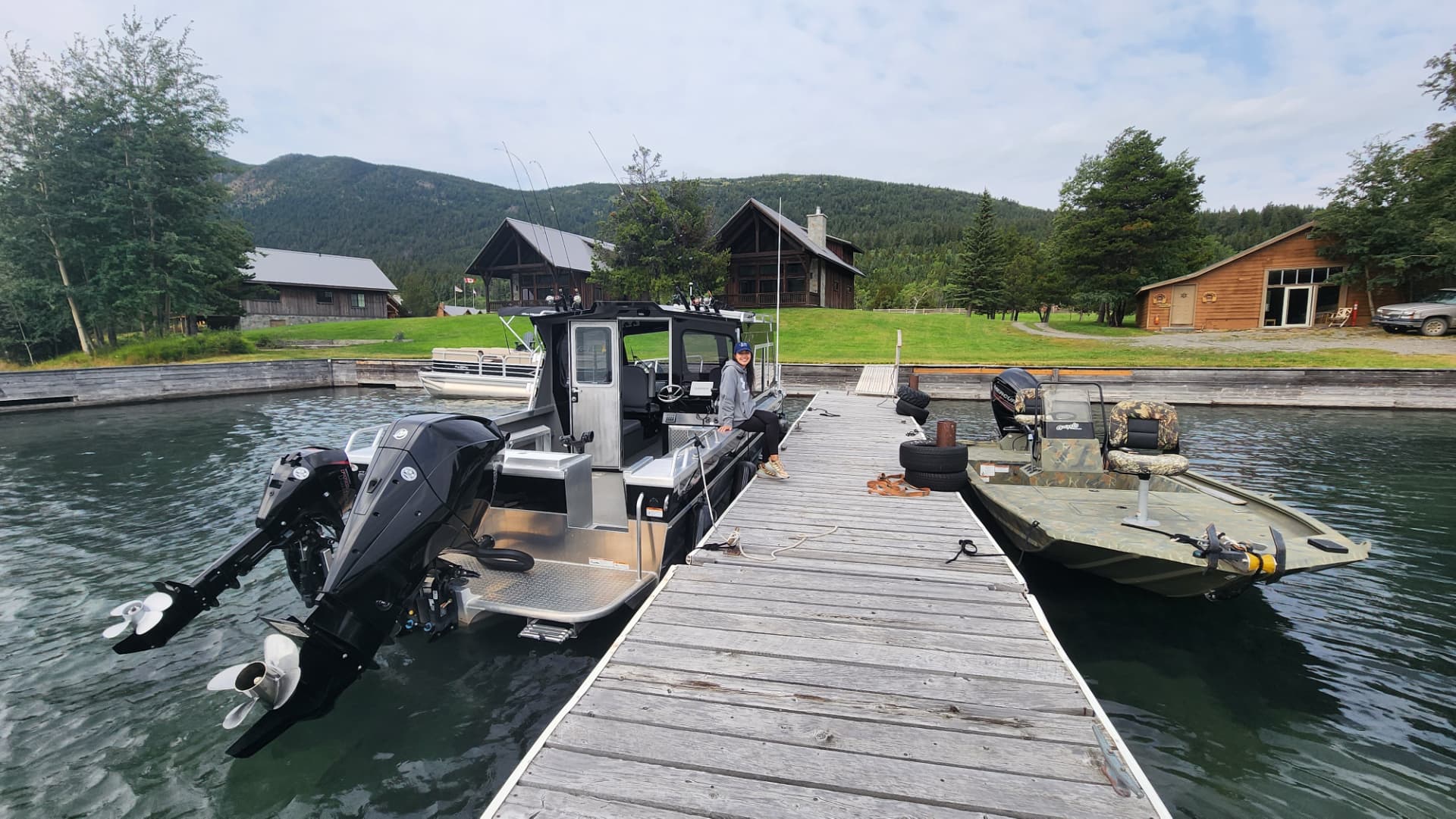Boats moored at the lodge dock with the lodge and forest behind